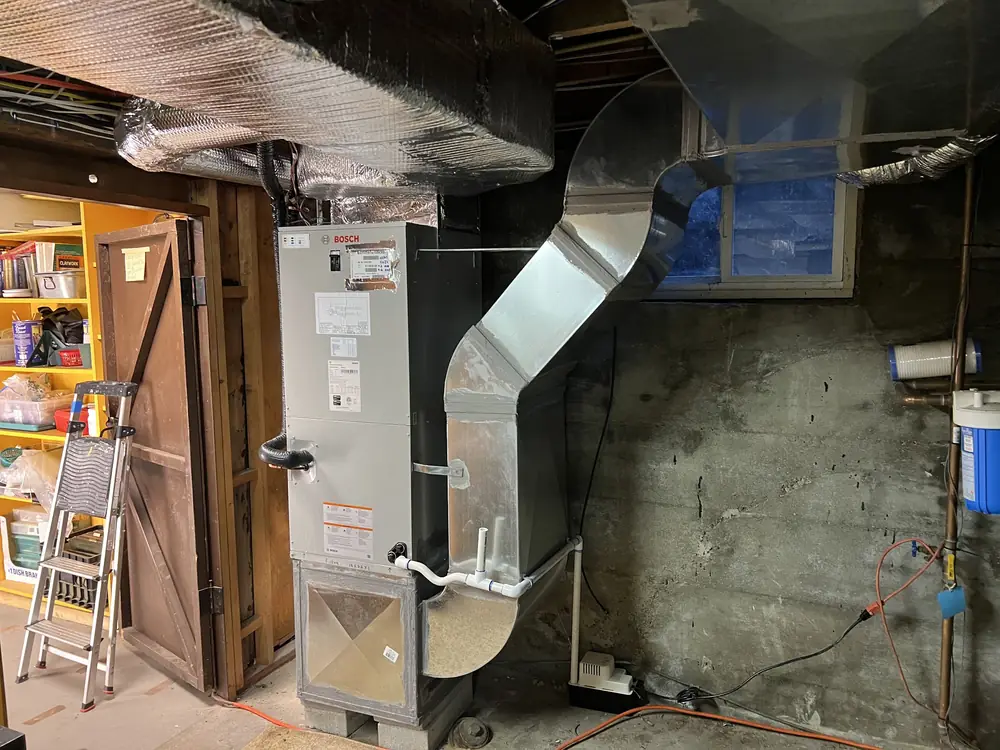 Bosch air handler connected to new sheet metal ductwork in a basement