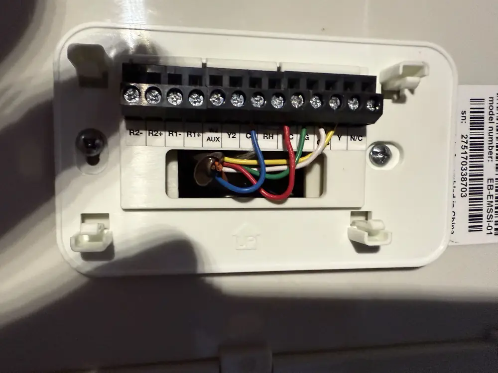 Thermostat subbase with control wiring landed on the terminals